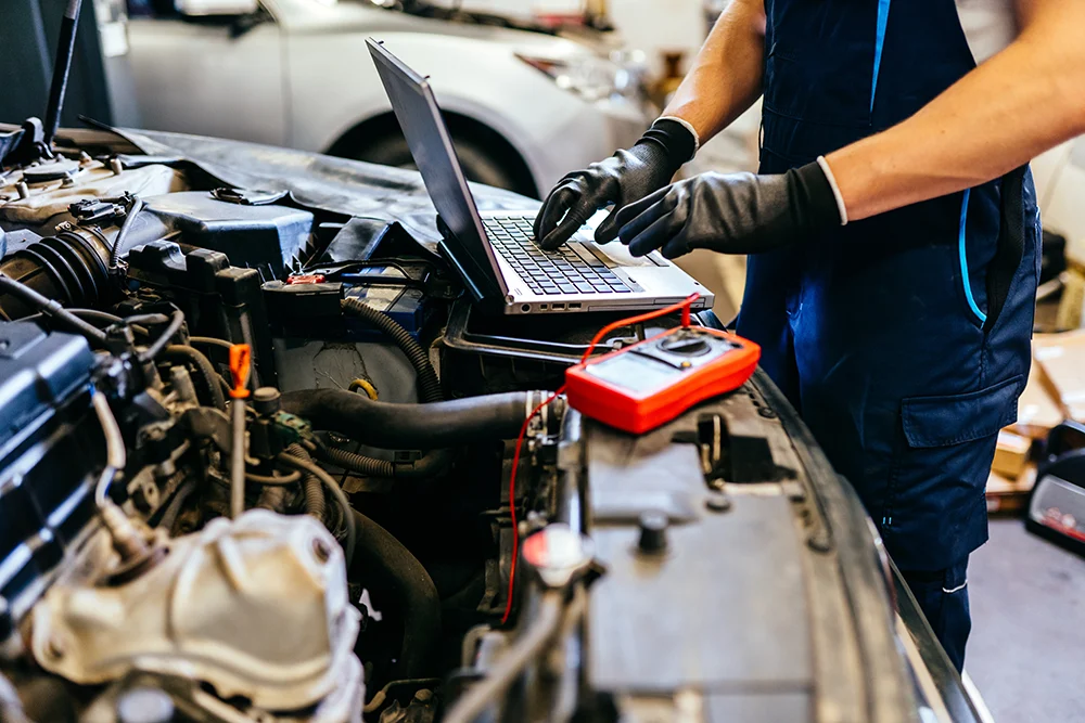 A technician runs diagnostics on a car